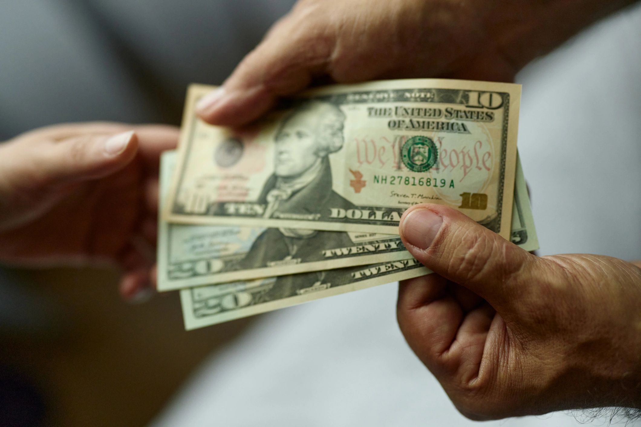 Customer handing cash at a service counter