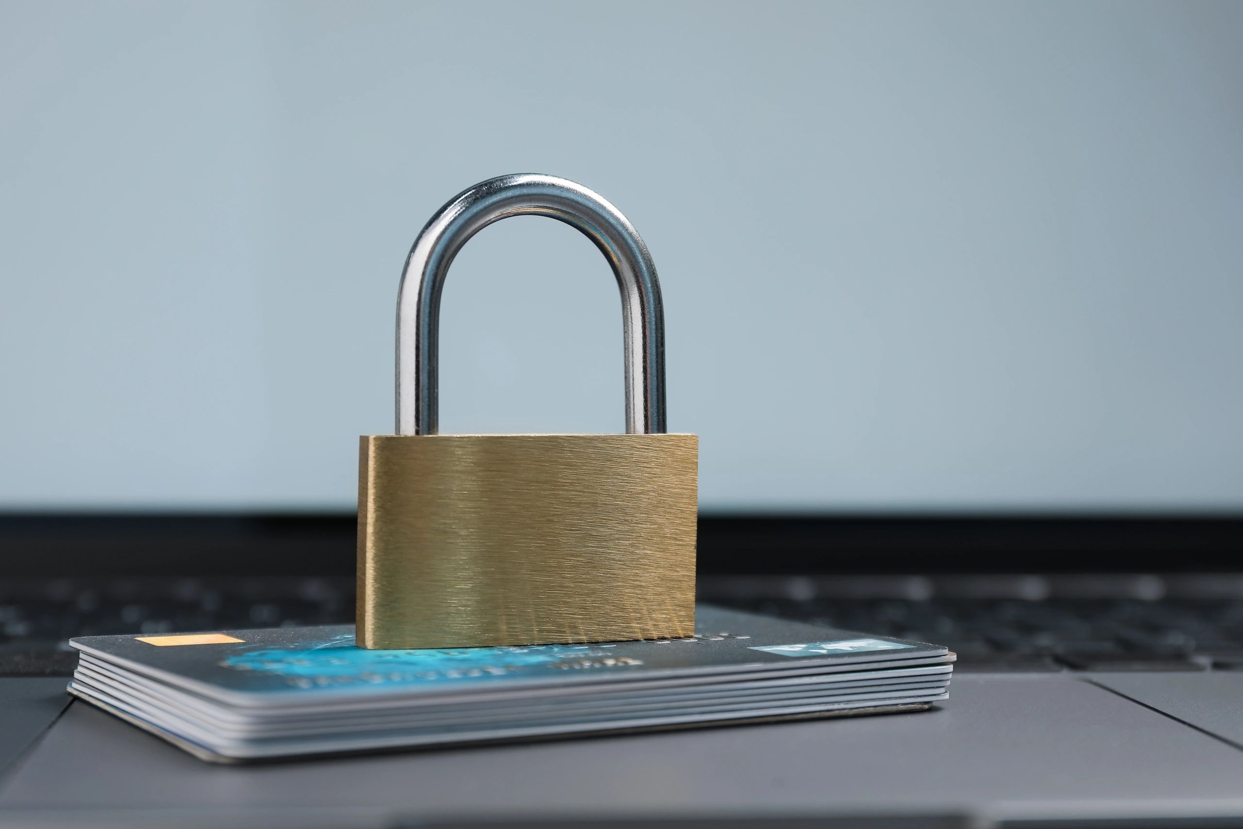 Padlock and credit cards on a laptop representing secure online payments